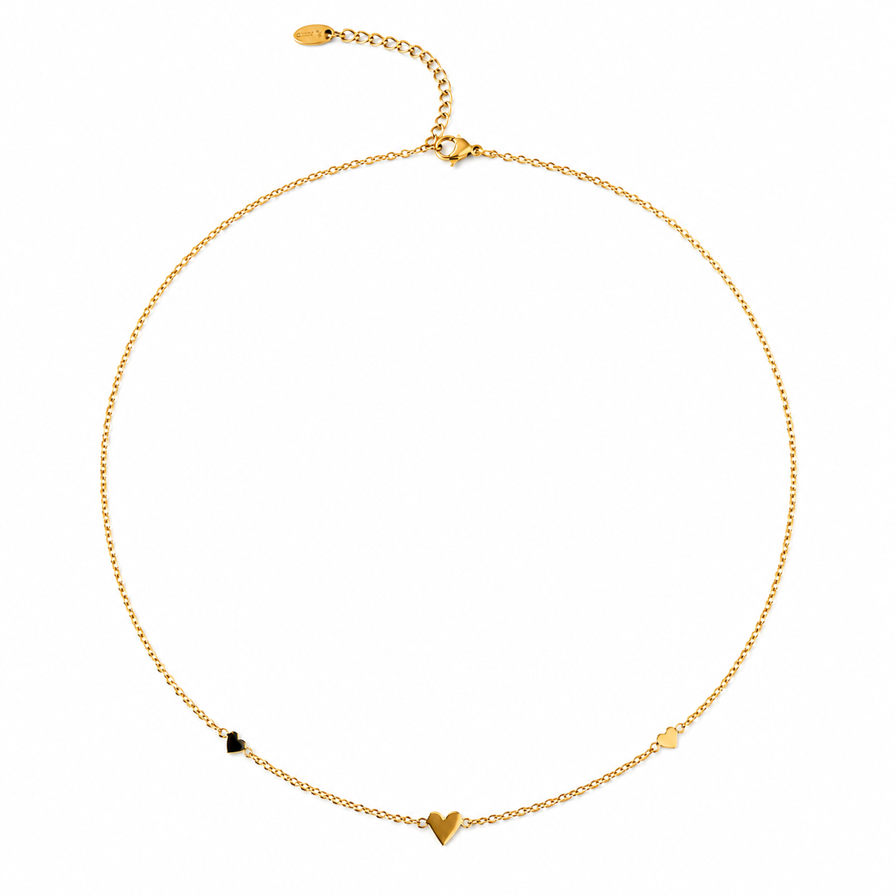 A delicate gold chain necklace with three small heart charms in gold, black, and white, displayed on a clean white background.