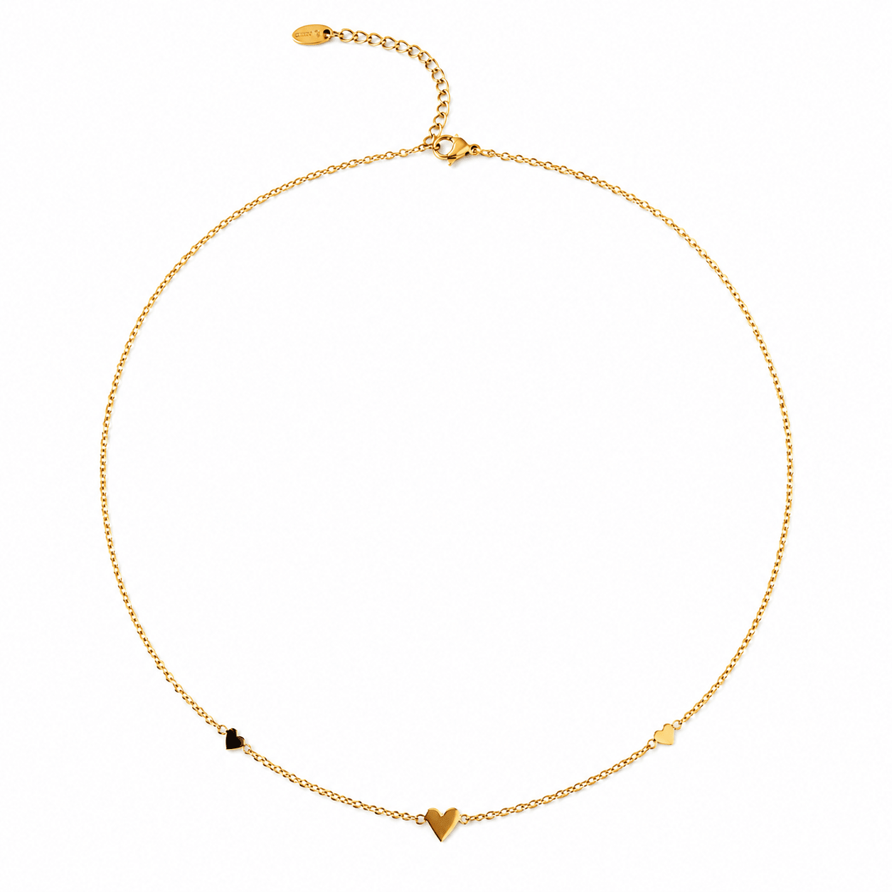 A delicate gold chain necklace with three small heart charms in gold, black, and white, displayed on a clean white background.