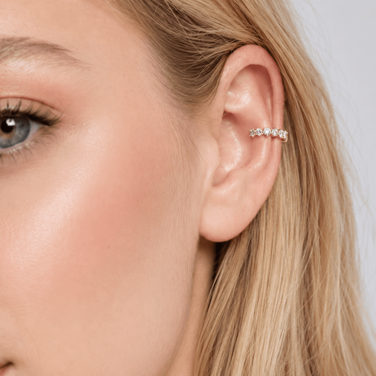 Woman wearing the Mariana Gold Crystal Ear Cuff
