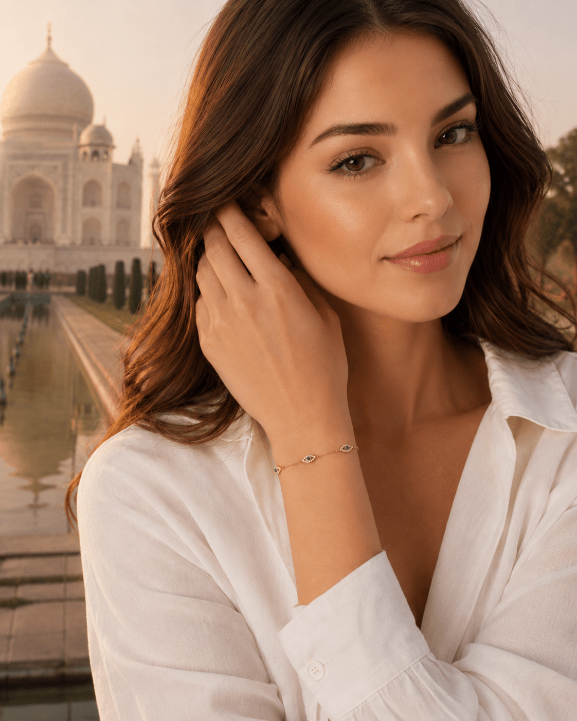 A woman wearing the Marlowe Gold Evil Eye Bracelet, photographed in front of the Taj Mahal.