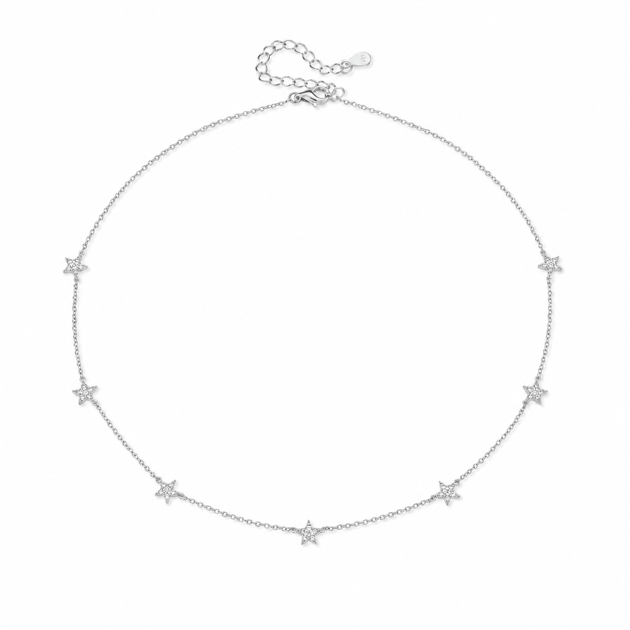 Woman wearing the Lola gold star station necklace layered with other chains