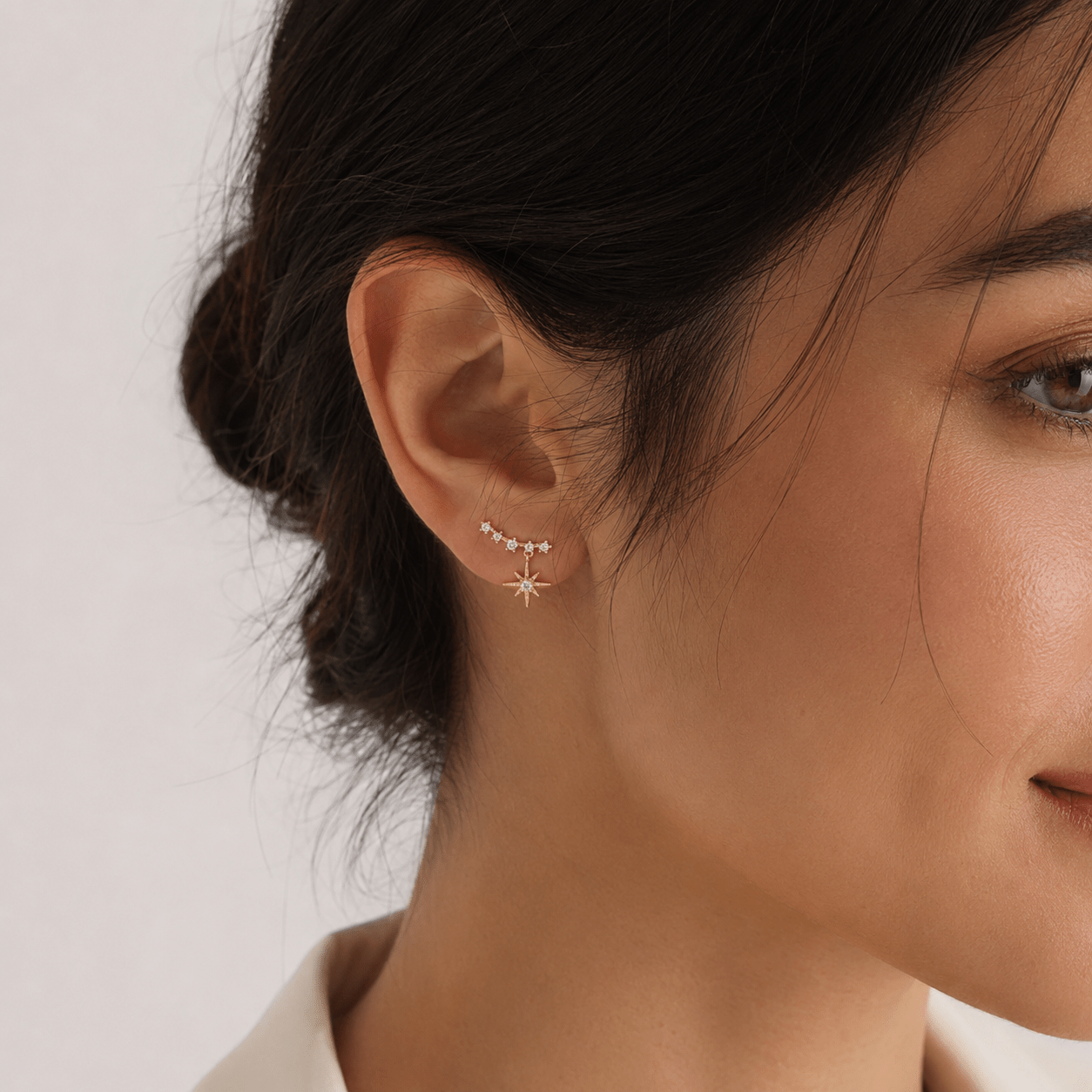 Close-up of Maeve Gold Star Drop Earrings showing the star charm