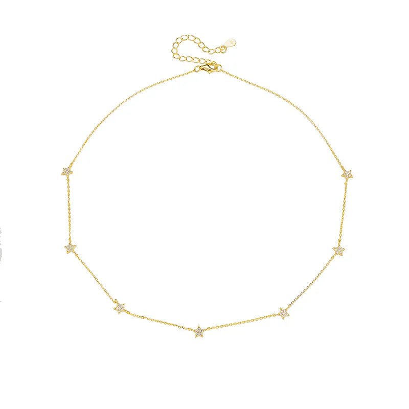 Lola gold star station necklace with CZ star charms on a box chain, front view