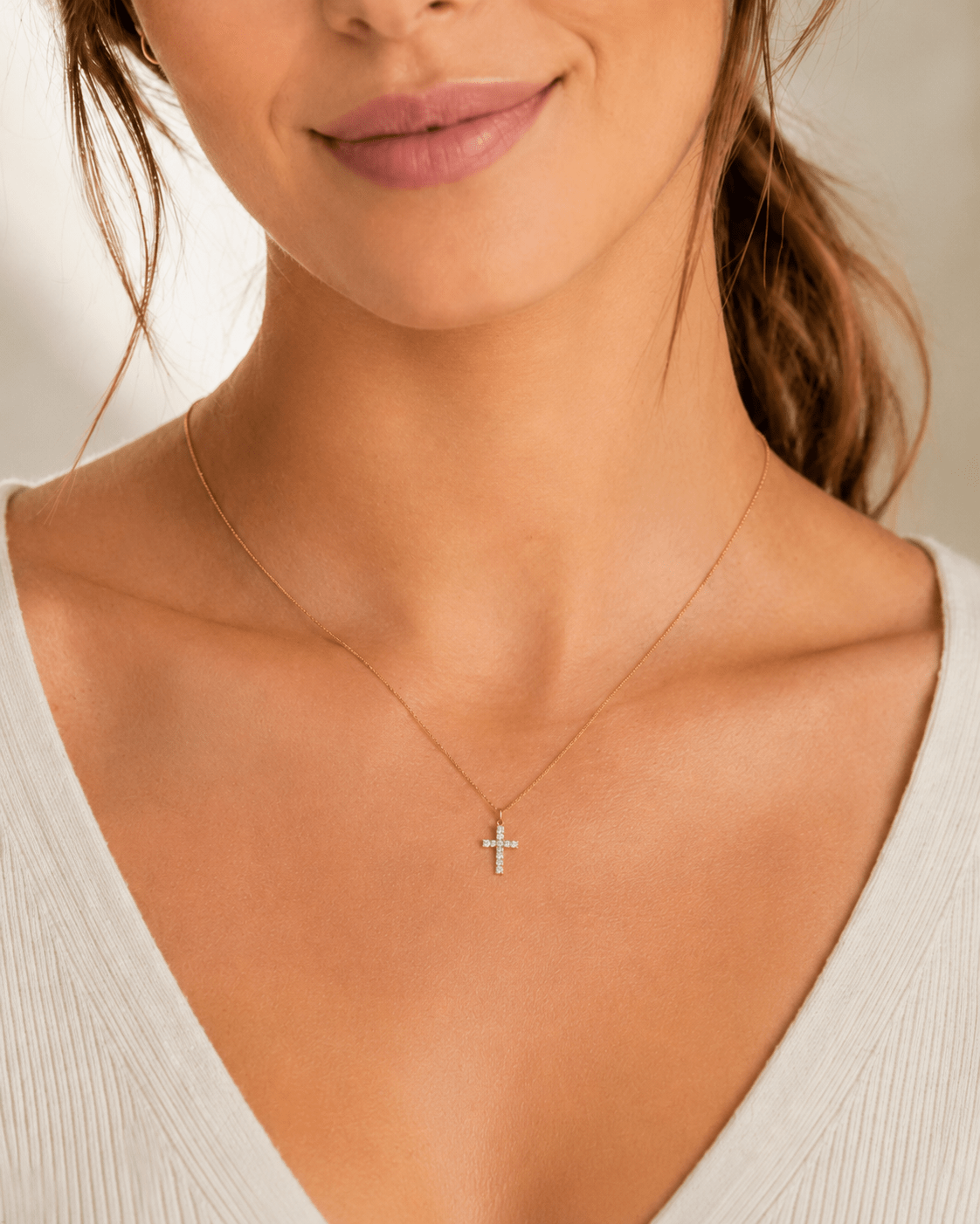 Side view of Vera Gold Mini Cross Necklace showing the chain and clasp