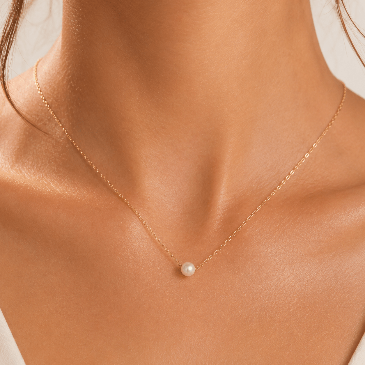 Side view of Addison Gold Pearl Station Necklace showing the chain