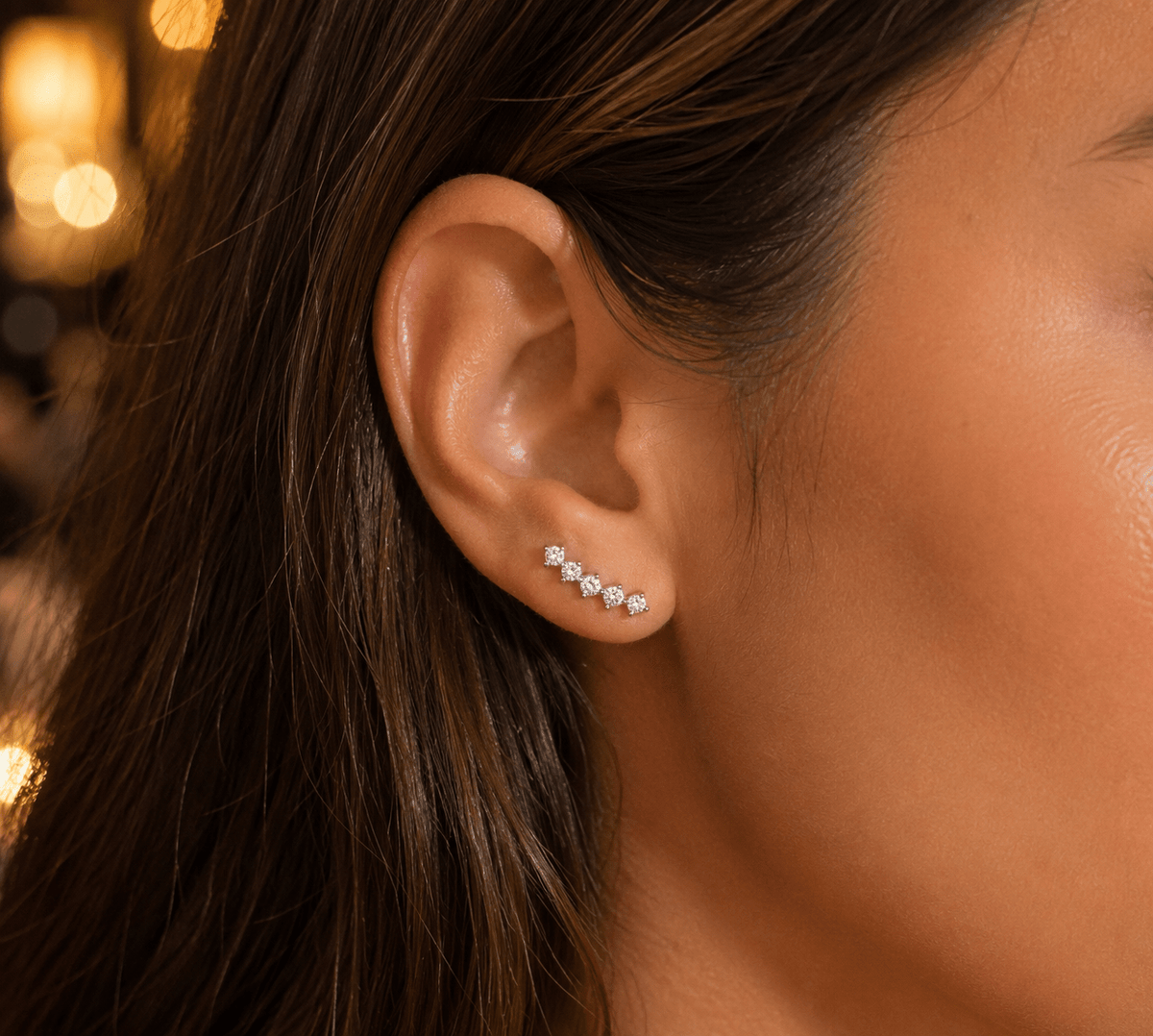 Woman wearing the Celestia Crystal Star Climber Earrings