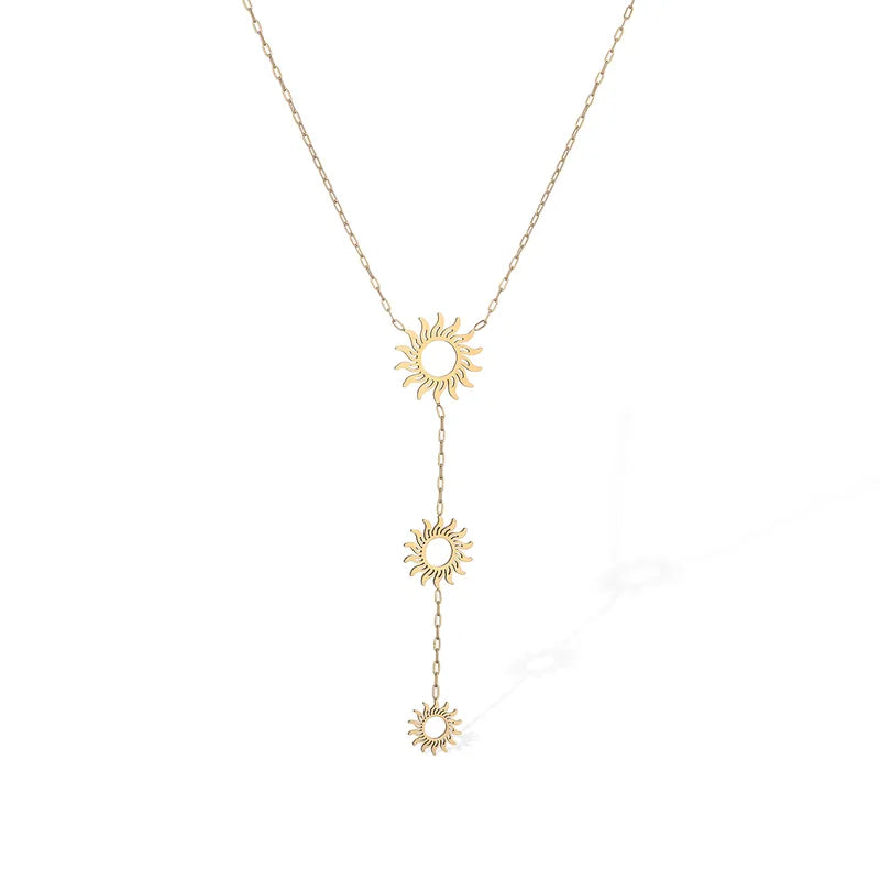 A delicate gold Y-necklace featuring three small sunburst charms connected by short chains, displayed against a clean white background.